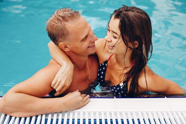 elegant-couple-swim-in-the-pool-XNWHKDR.jpg